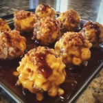 Close-up of Smoky Maple Bourbon BBQ Pulled Pork Mac & Cheese Bombs showing cheesy interior and sweet glaze